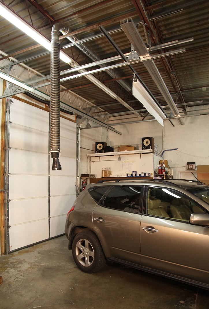 Telescoping garage exhaust removal system shown installed in a service garage.