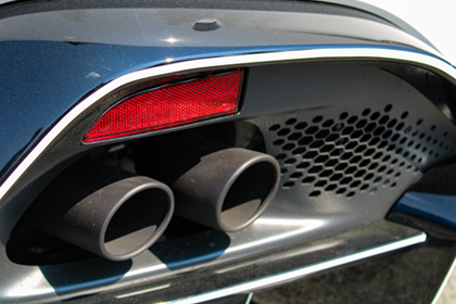 The tailpipes of a blue car.
